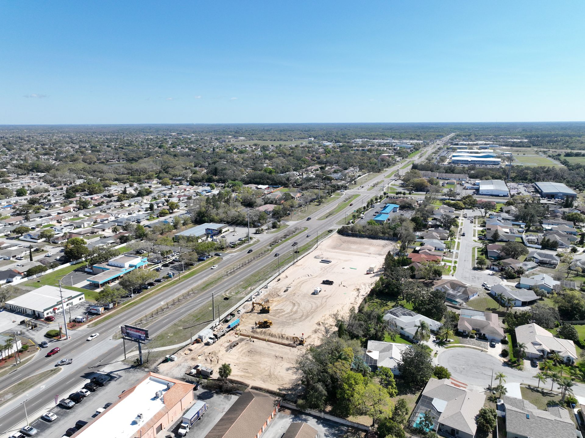 An aerial view of a city with a lot of houses and a highway.