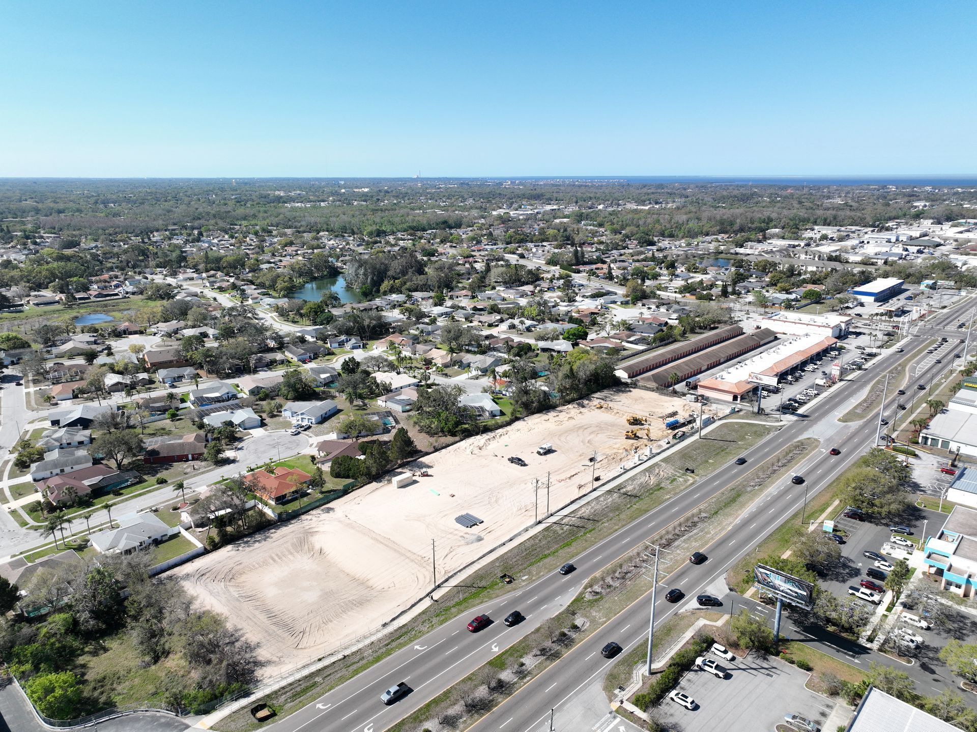 An aerial view of a city with a lot of buildings and a highway.