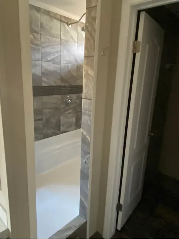 A bathroom with a walk in shower and a bathtub