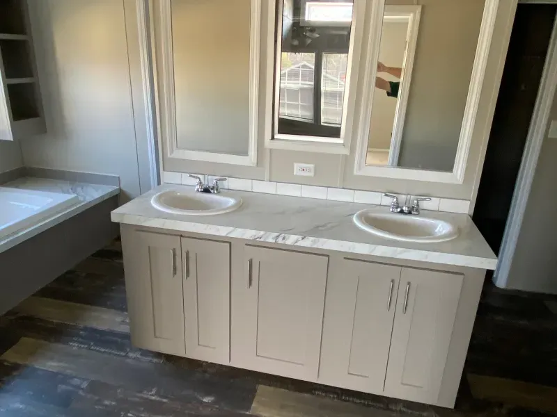 A bathroom with two sinks and two mirrors.