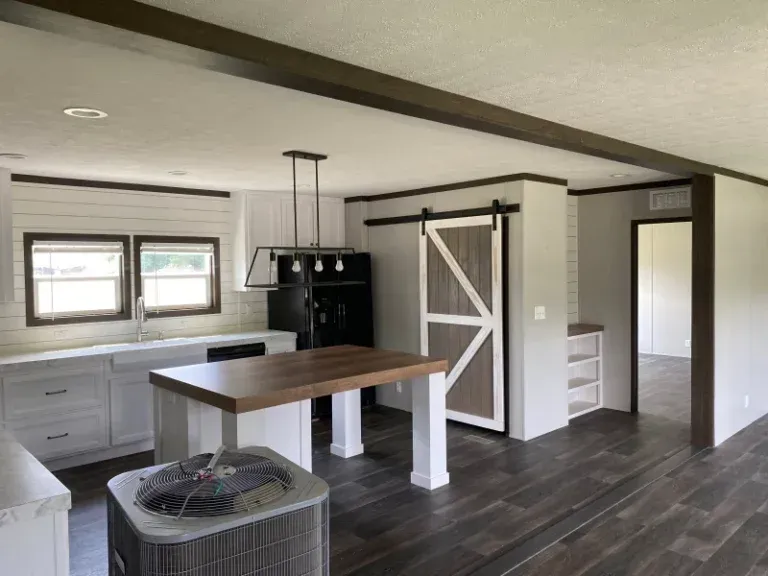 A kitchen with a wooden table and a sliding barn door
