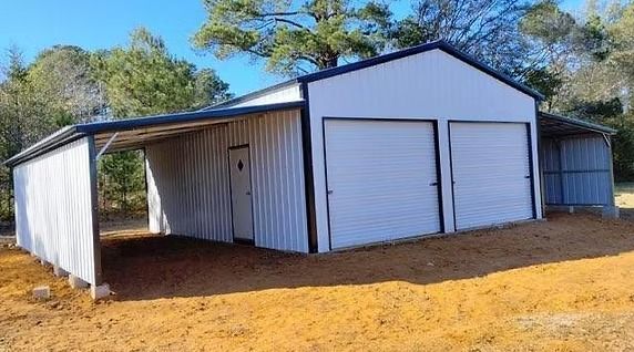 A white metal garage with two garage doors and a canopy.