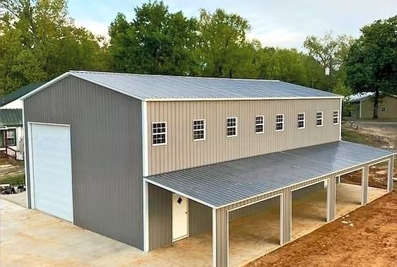 A large metal building with a roof and a lot of windows.