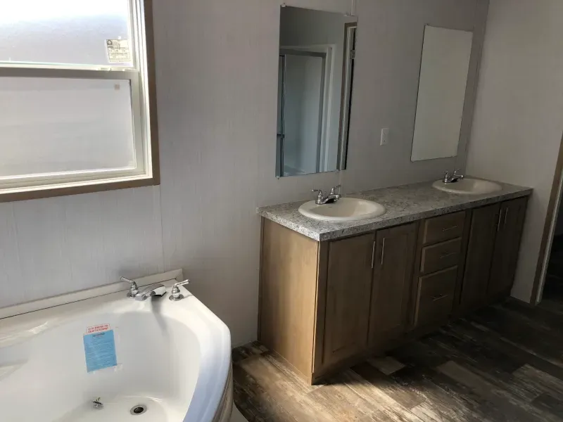 A bathroom with two sinks and a bathtub.