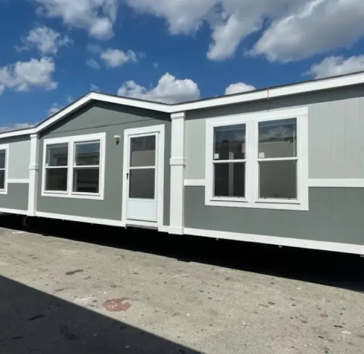 A mobile home with a blue sky in the background