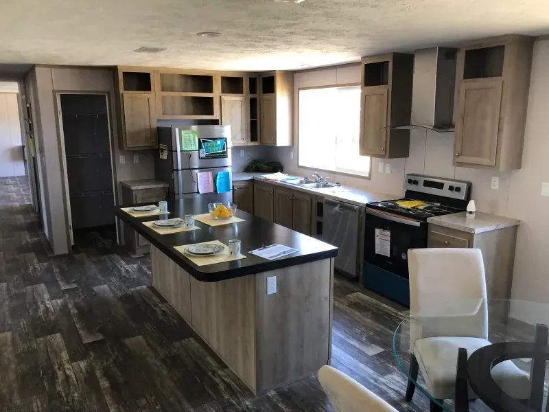 A kitchen with a large island and a stove.