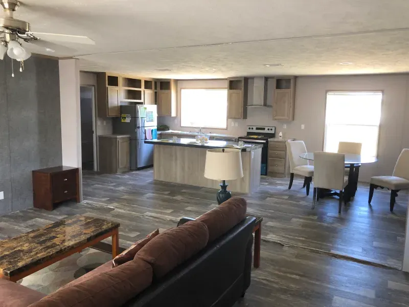 A living room filled with furniture and a ceiling fan
