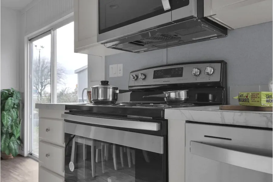 A kitchen with a stove , oven and microwave.