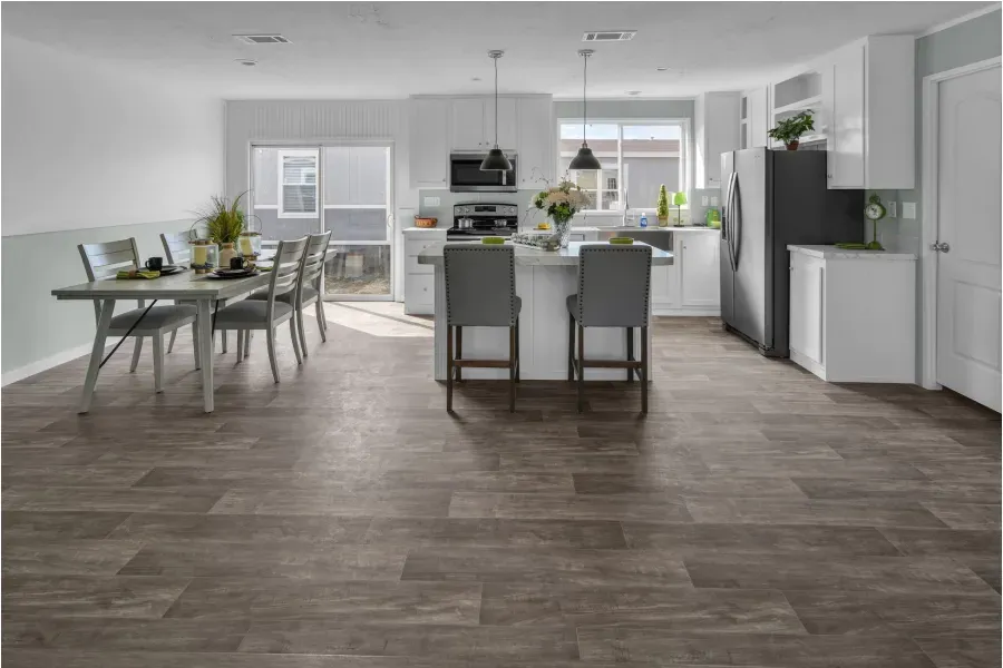 A kitchen and dining room with wooden floors and white cabinets.