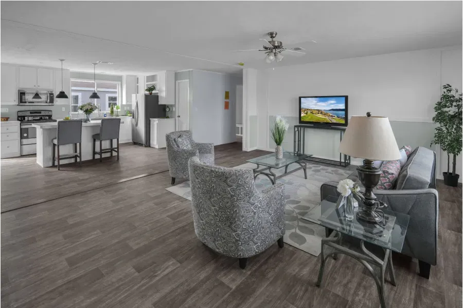 A living room with a couch , chairs , a table and a television.