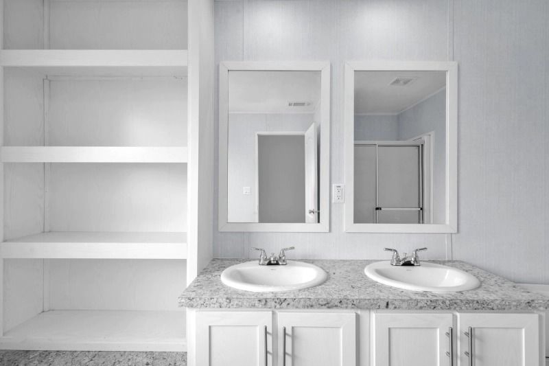 A bathroom with two sinks and two mirrors.