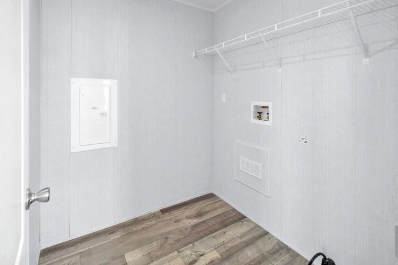 A laundry room in a mobile home with a washer and dryer.