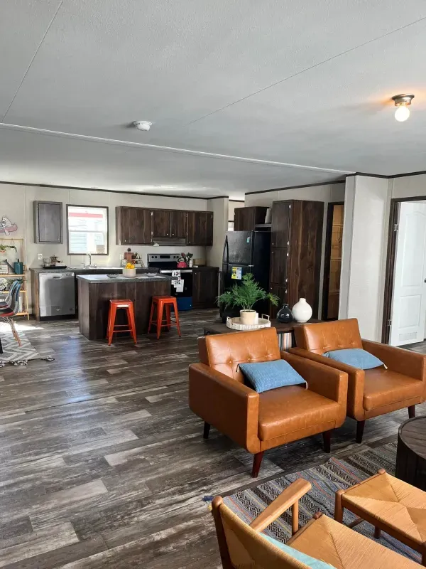 A living room filled with furniture and a kitchen.