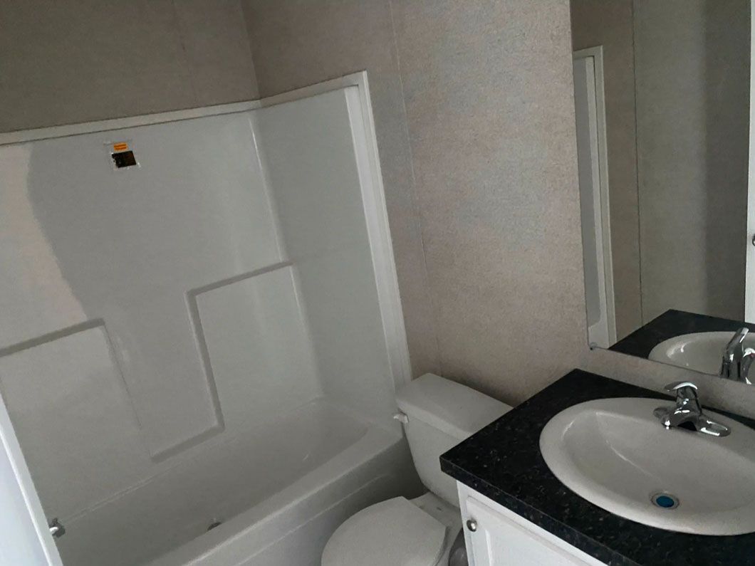 A bathroom with a sink , toilet and bathtub.