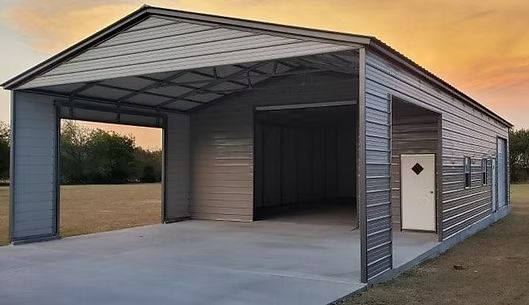 A metal garage with a concrete driveway and a door.