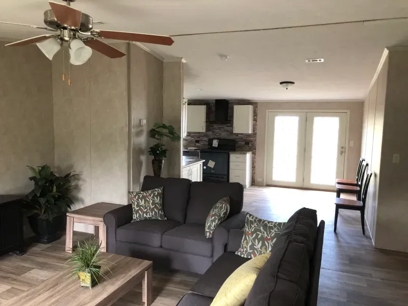 A living room with a couch and a ceiling fan