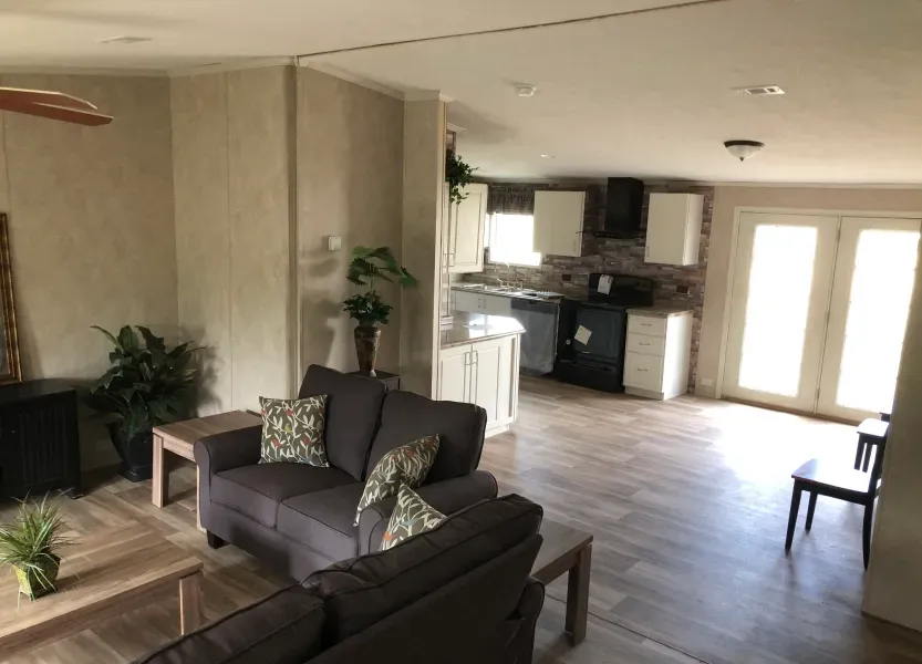 A living room in a mobile home with a couch and a table