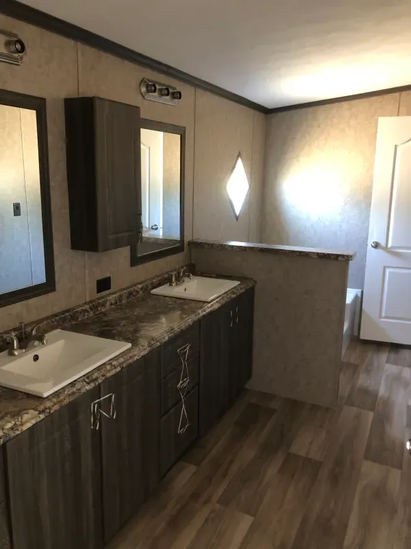 A bathroom with two sinks and two mirrors
