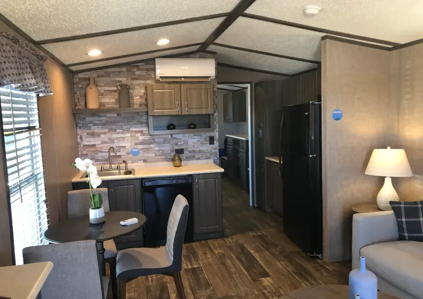A living room and kitchen in a mobile home