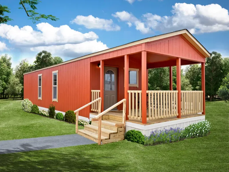 An orange mobile home with a porch and stairs