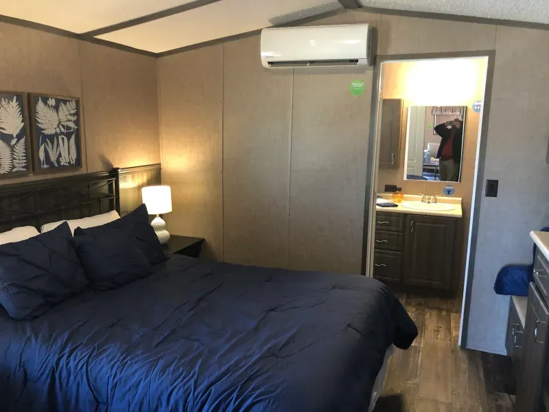 A bedroom with a king size bed and a bathroom
