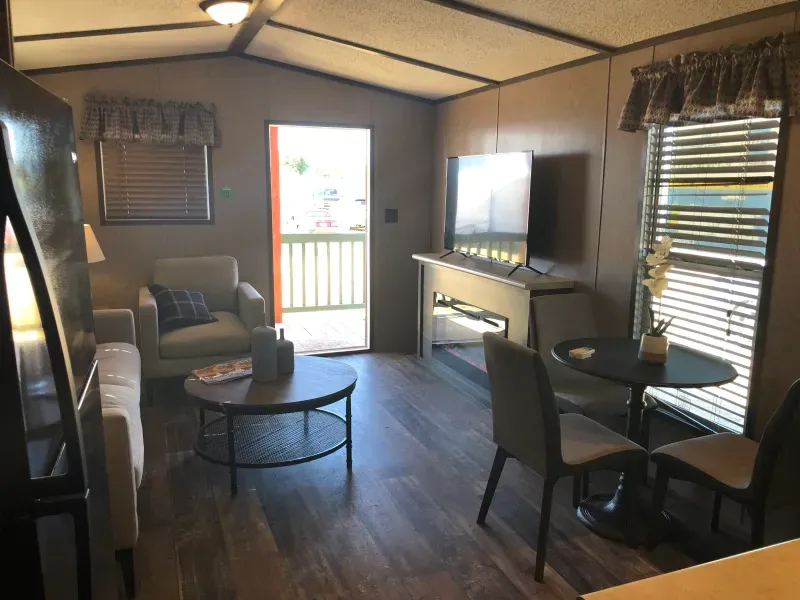 A living room with a couch , chair , table and television