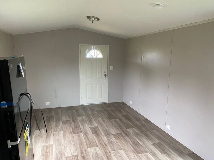 There is a refrigerator in the middle of the room.