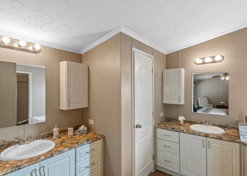 A bathroom with two sinks and a mirror.
