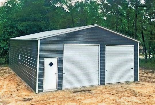 A metal garage with two white garage doors and a white door.