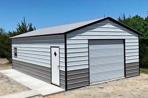 A white and gray metal garage with a garage door.