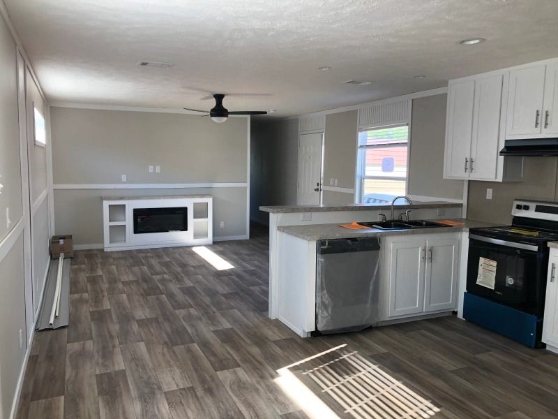 A kitchen with white cabinets and a black stove