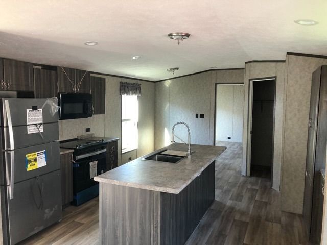 A kitchen with stainless steel appliances and a large island