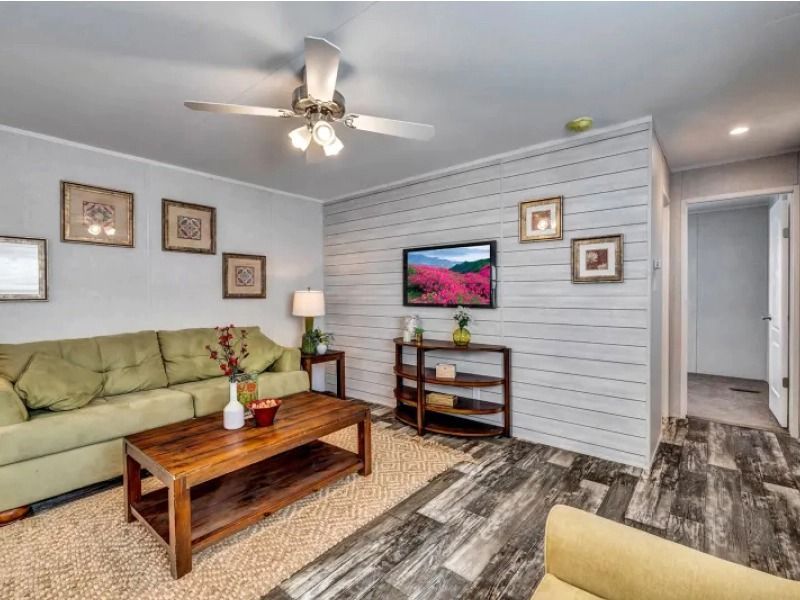 A living room with a couch , coffee table , and television.