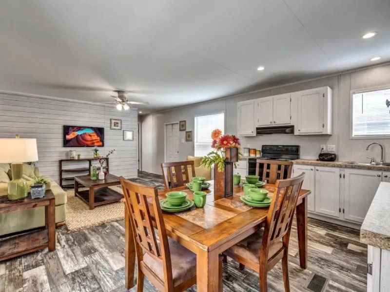 There is a dining table and chairs in the middle of the room.