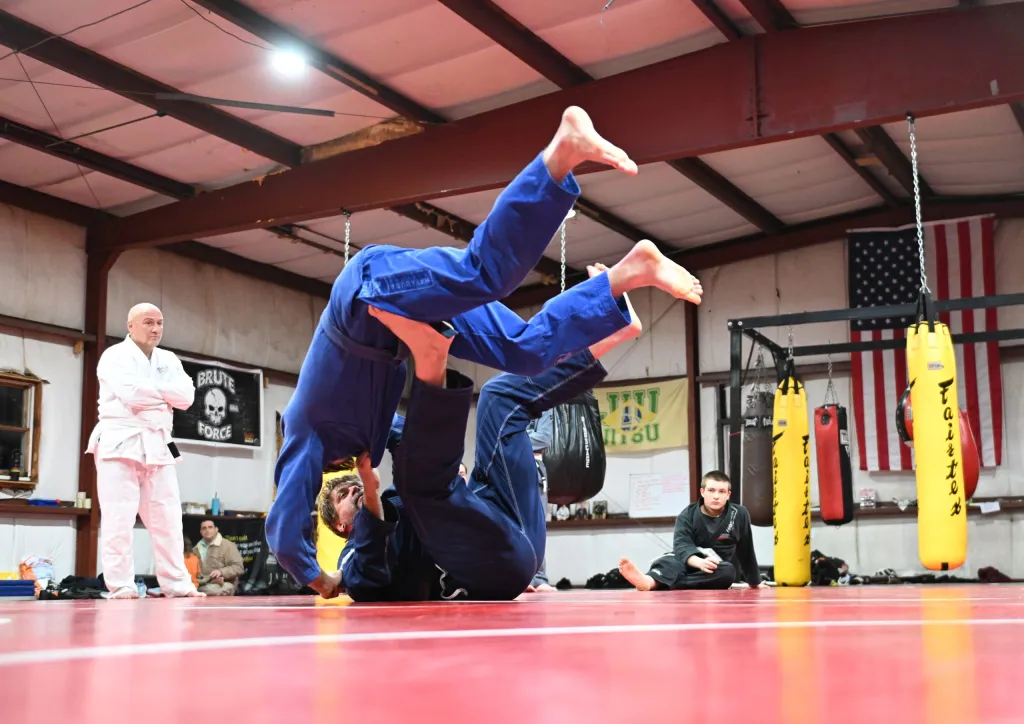 Adults training jiu jitsu at Roberts Family Mixed Martial Arts in Orange, MA, building confidence.