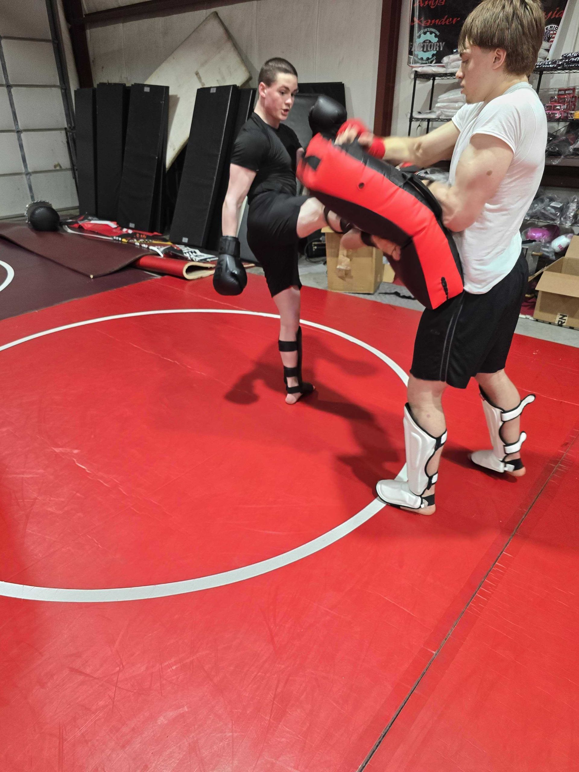 Beginner students practice safe striking drills at Roberts Family Mixed Martial Arts in Orange, MA.