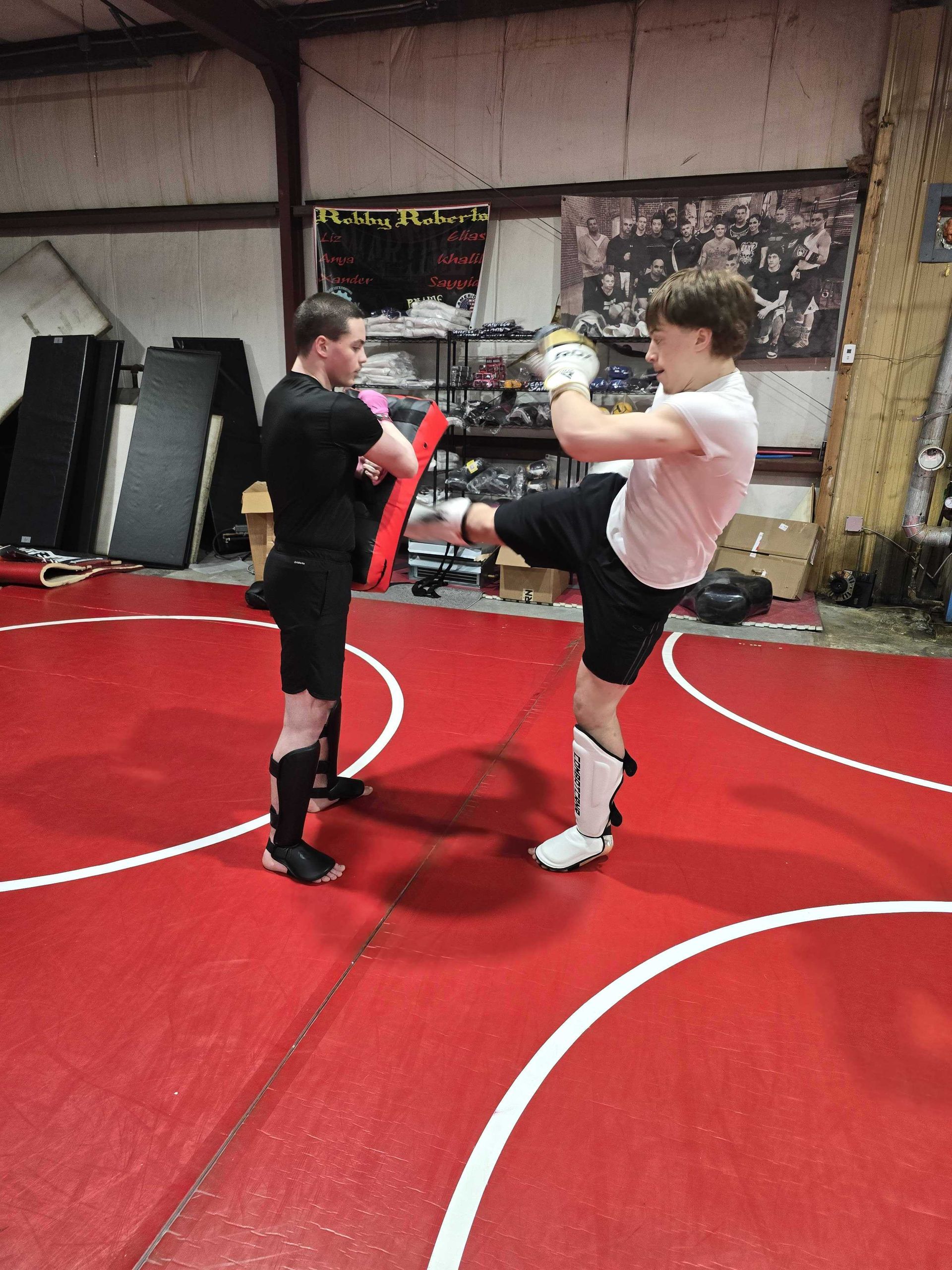 Adult beginners drilling jiu jitsu escapes and chokes at Roberts Family Mixed Martial Arts in Orange, MA for self-defense.