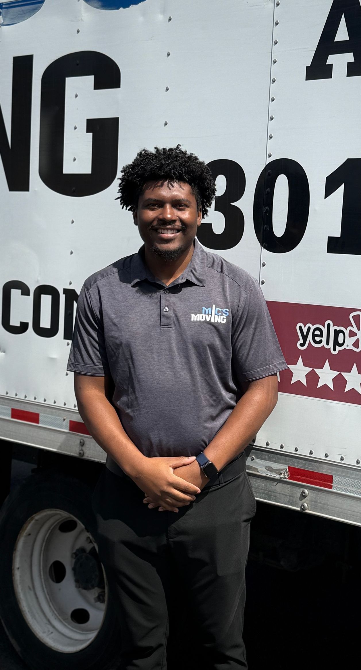 Ezra wearing a mic 's moving shirt is sitting at his office desk