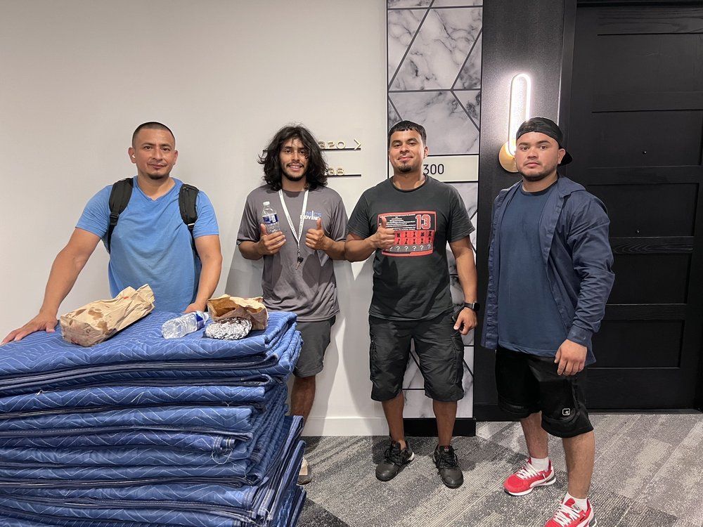 A group of Mic's Movers in business lobby ready to move a business.