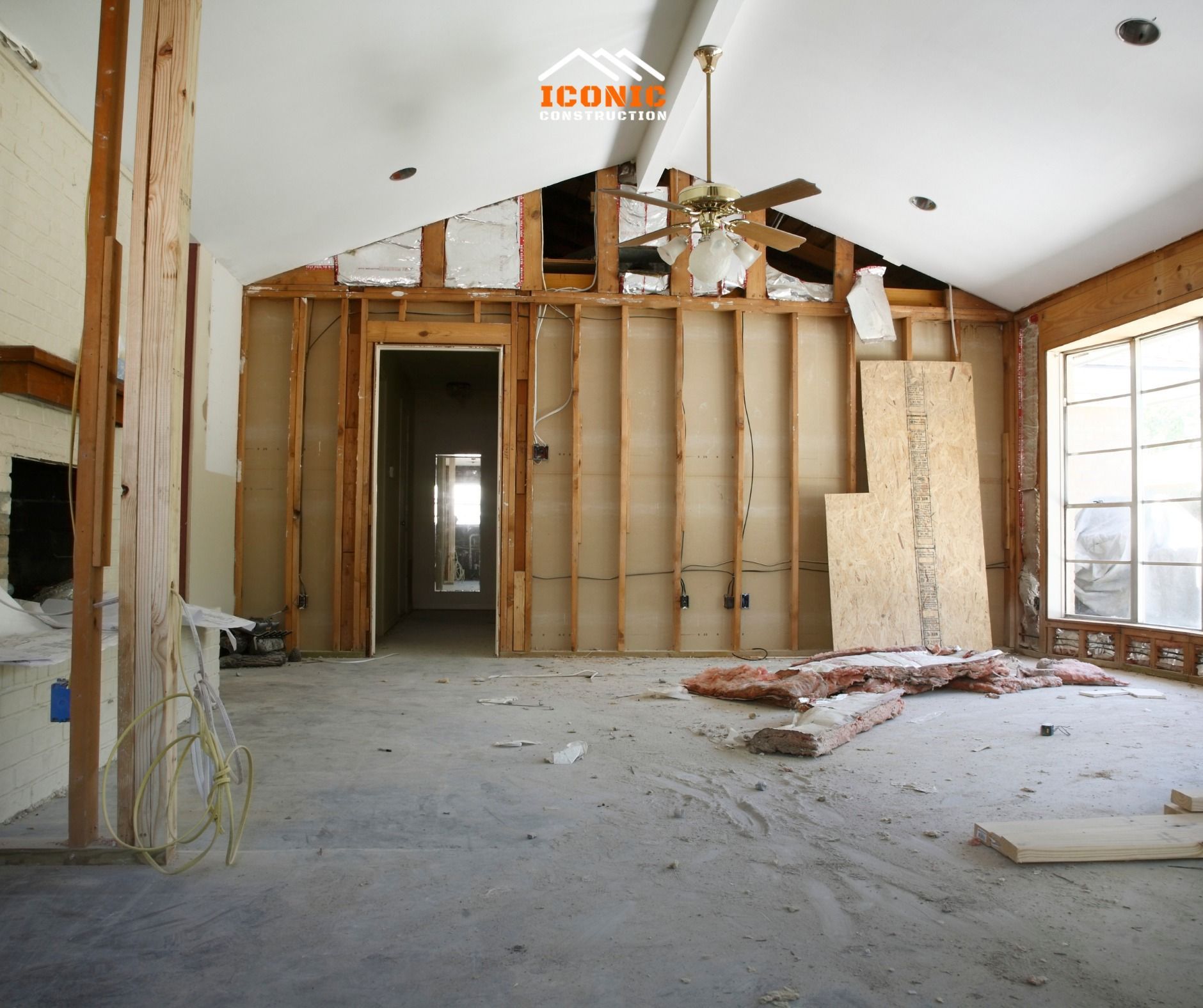 Interior of a room under renovation, walls stripped down to the wooden frame.