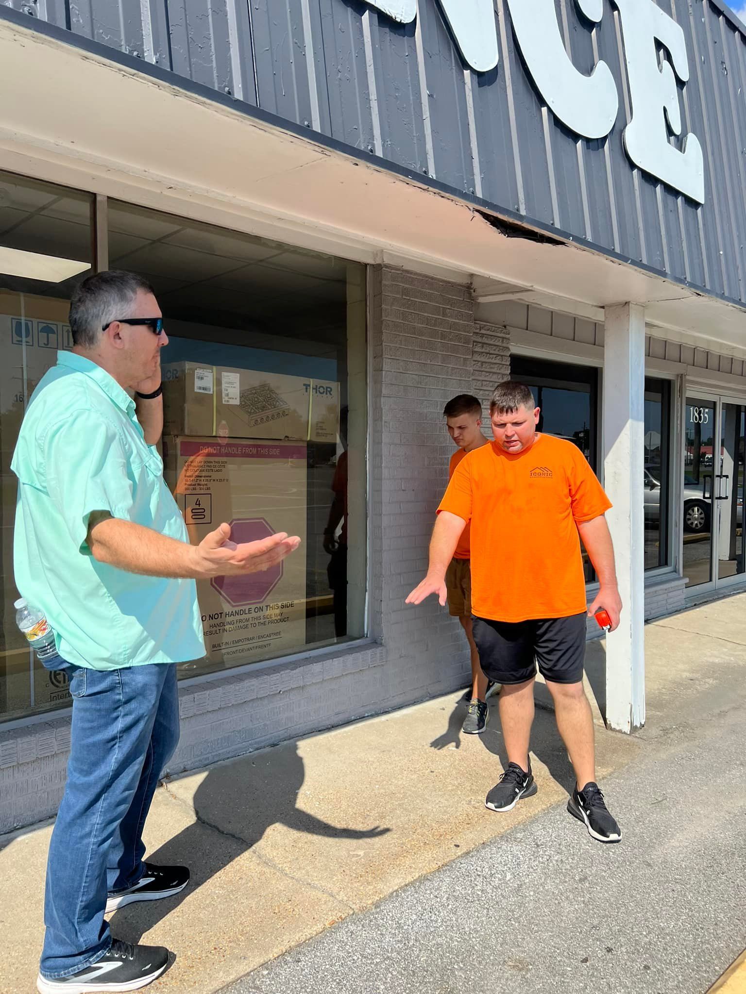 Three men outside a store with a 