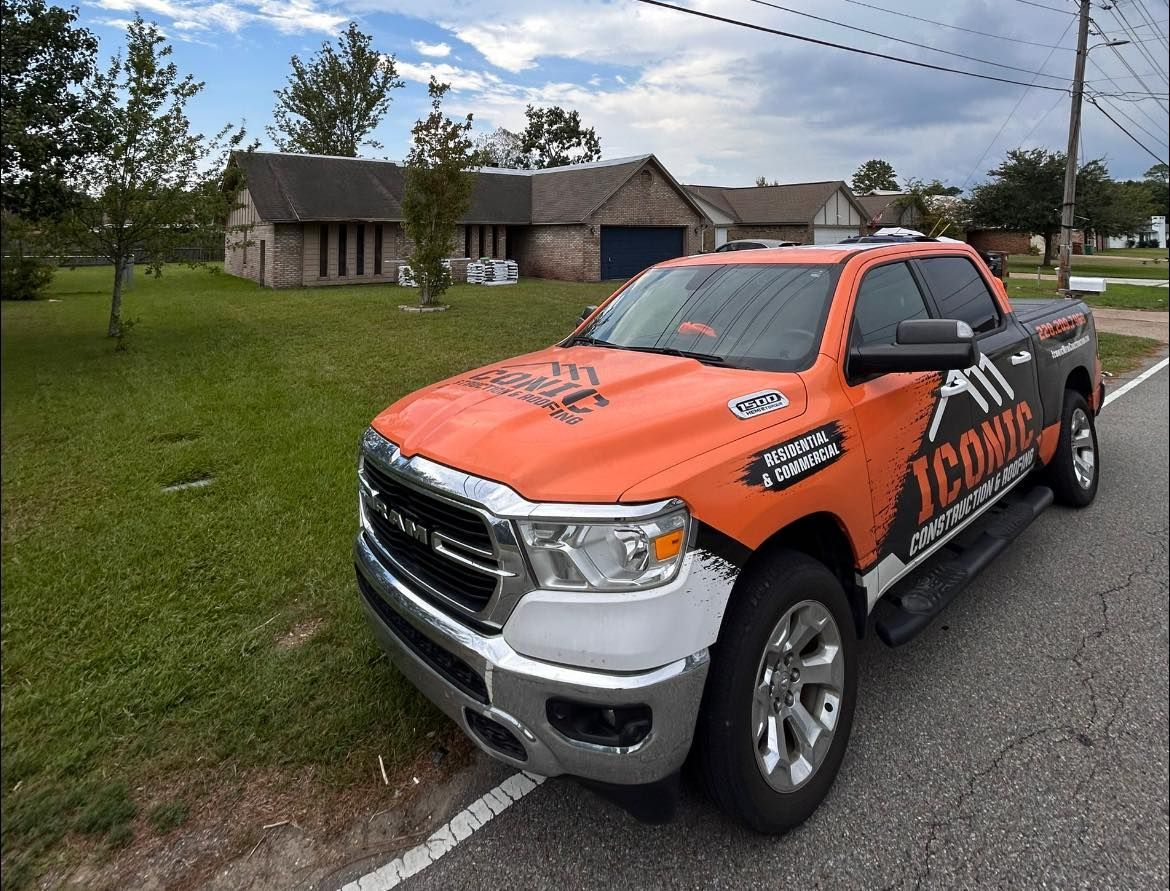 A bright orange and black Ram pickup truck with 