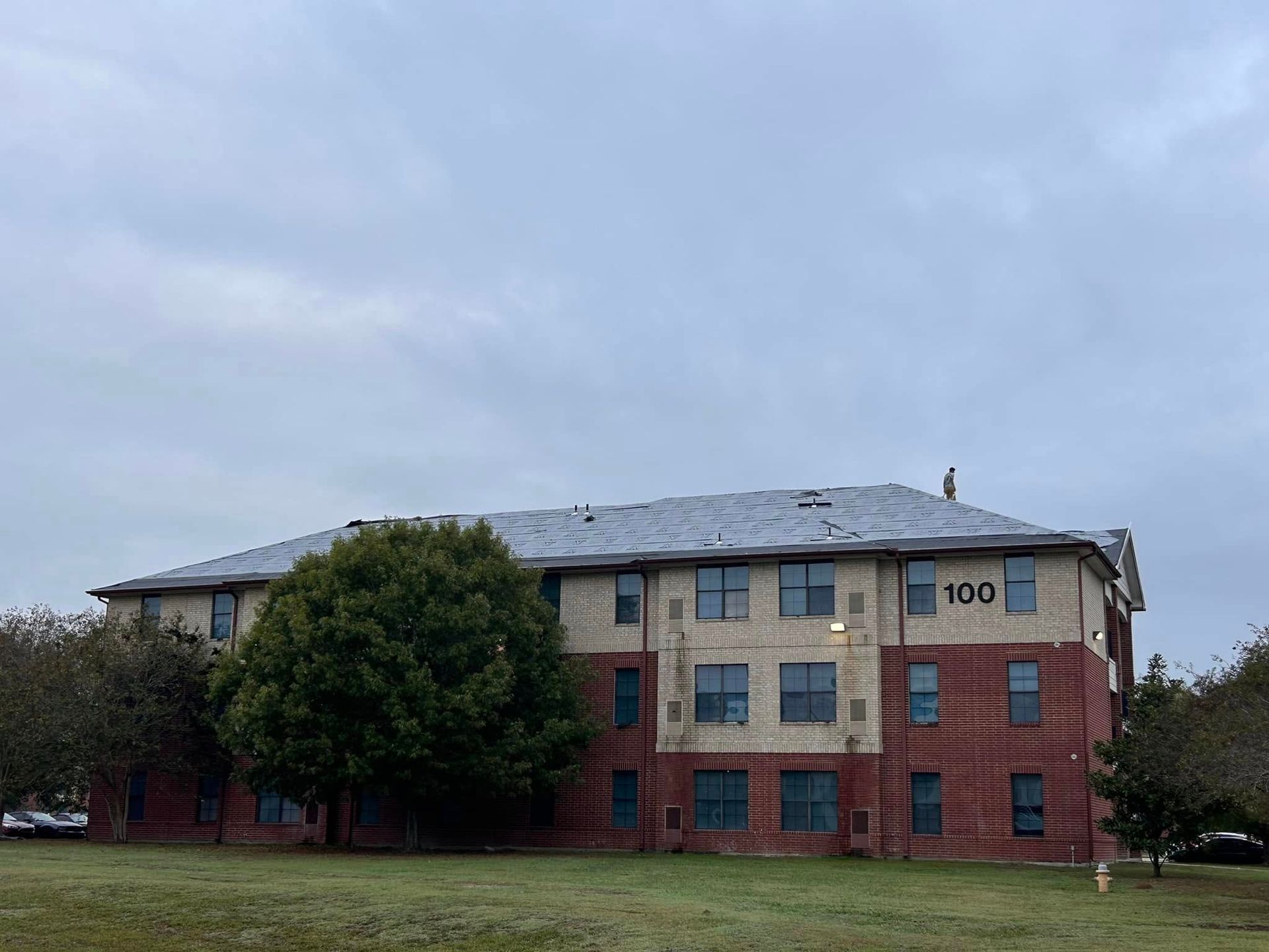 A three-story brick building with the number 