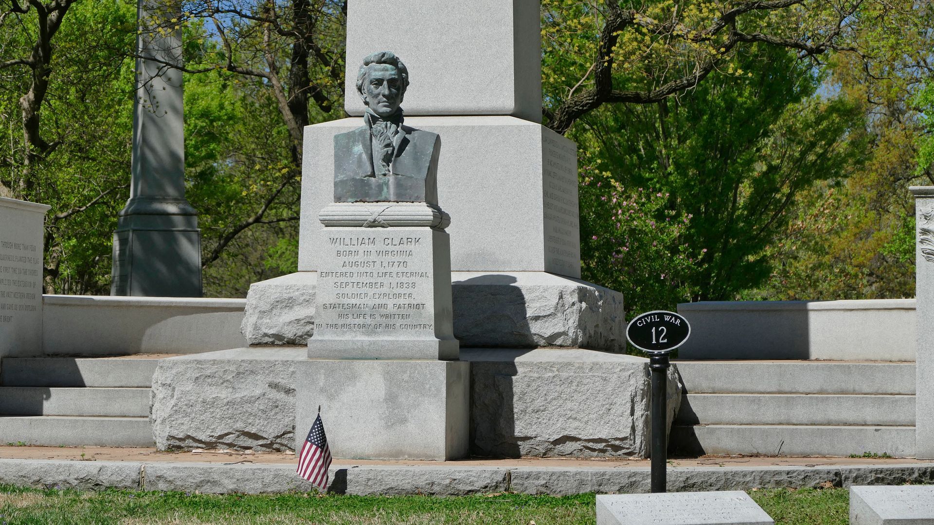 A statue in a cemetery with the number 12 on it