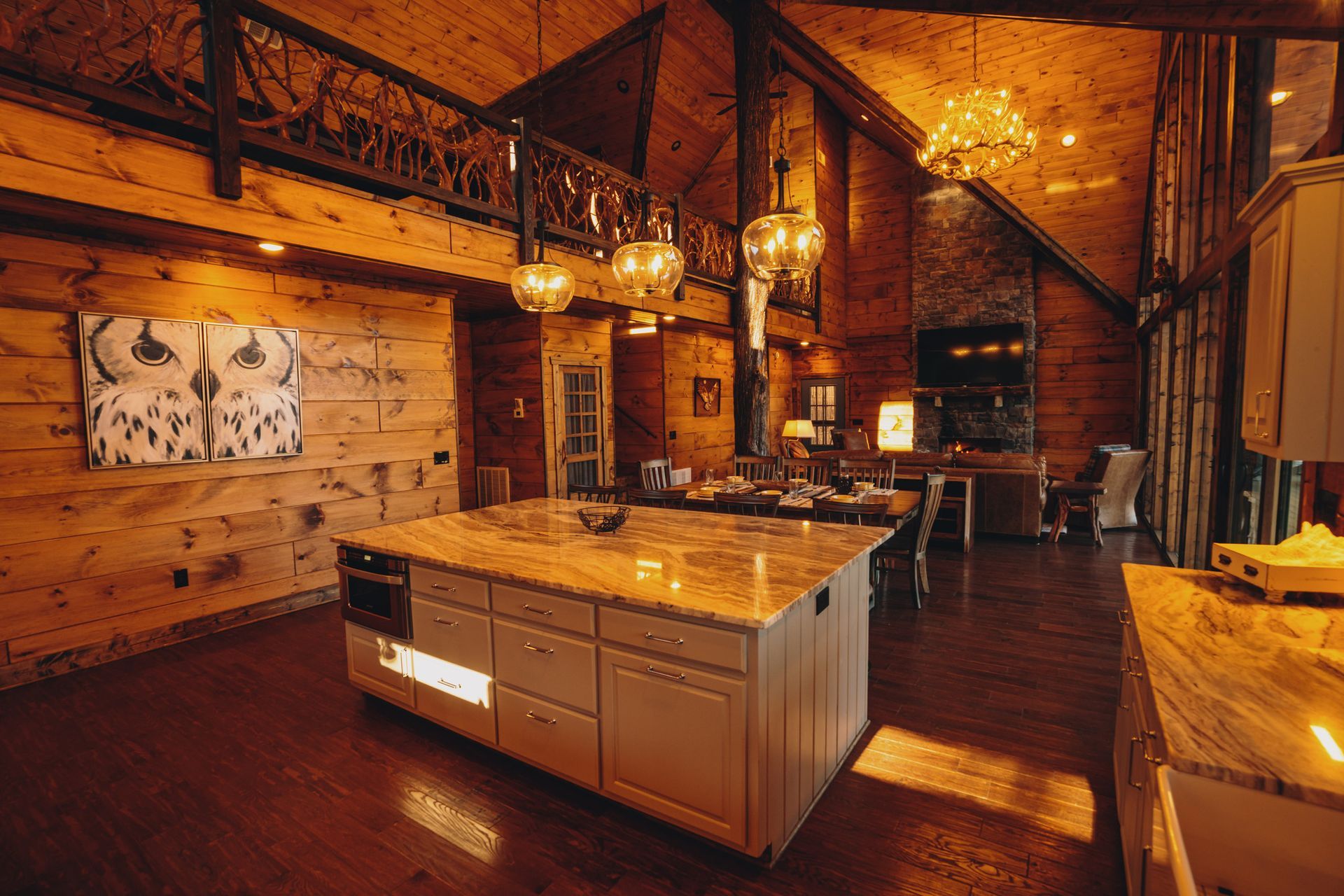 a large kitchen in a log cabin with a large island in the middle .