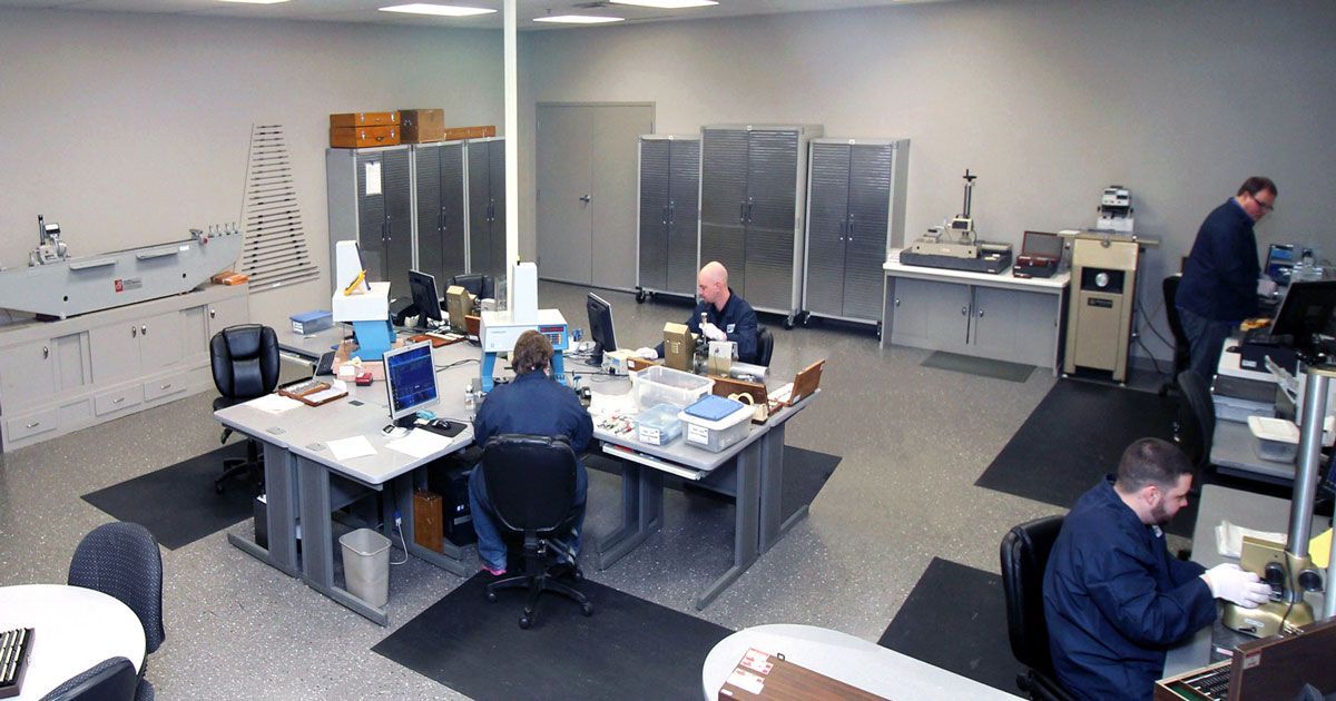 A People Are Sitting At Desks In An Office — New Berlin, WI — Quality Calibration Services