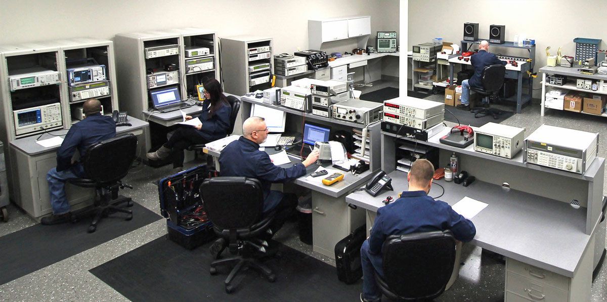 A People Are Sitting At Desks In A Room — New Berlin, WI — Quality Calibration Services