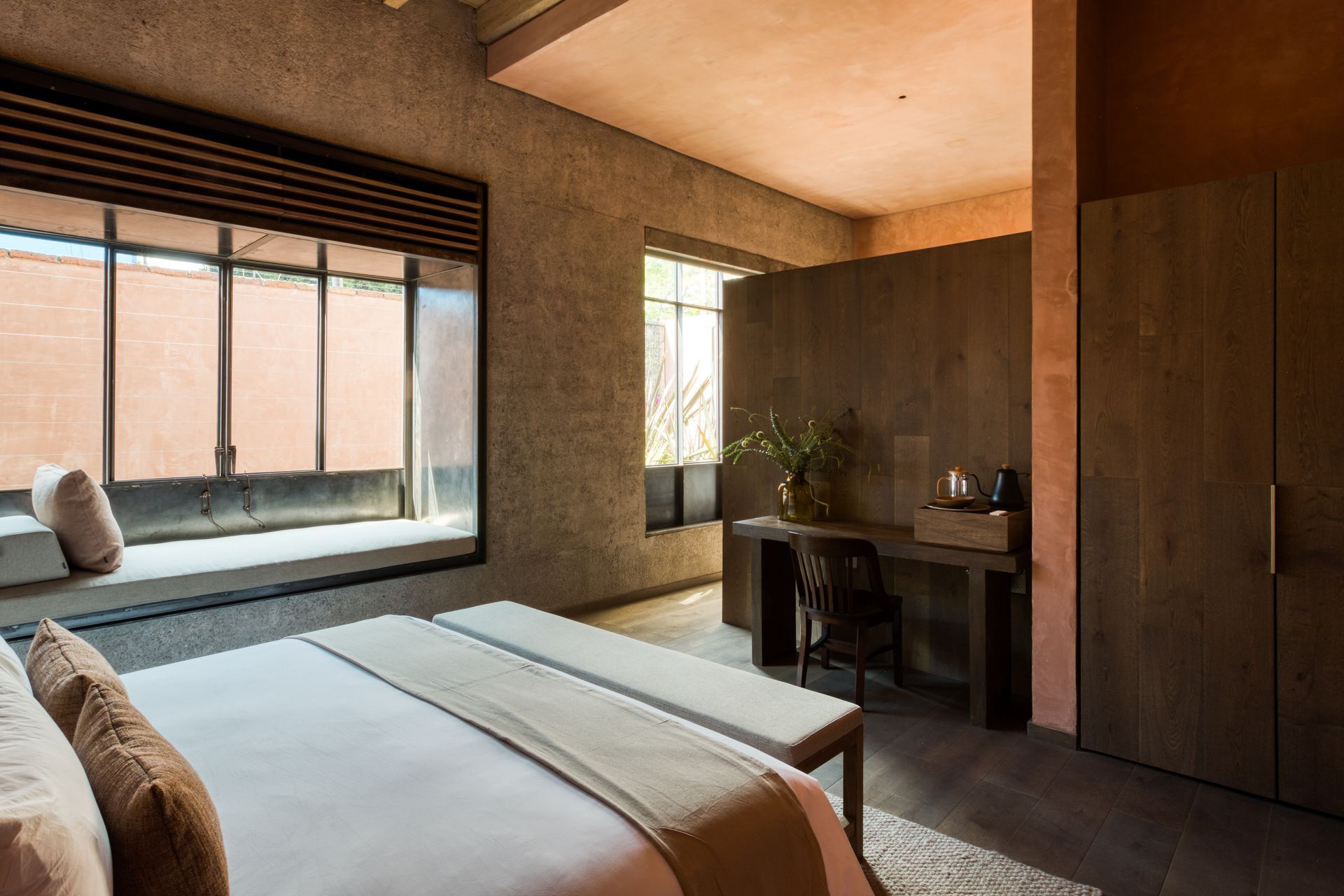 Hay una cama grande en el medio de la habitación con una ventana grande.