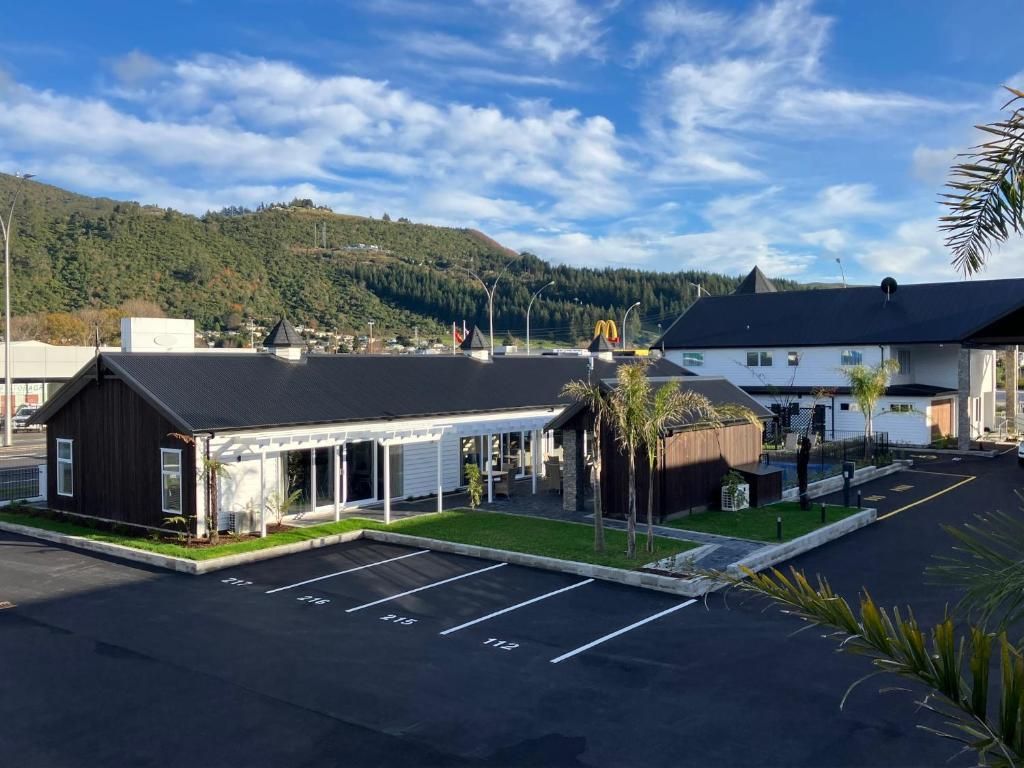 A large building with a lot of windows and a parking lot in front of it.