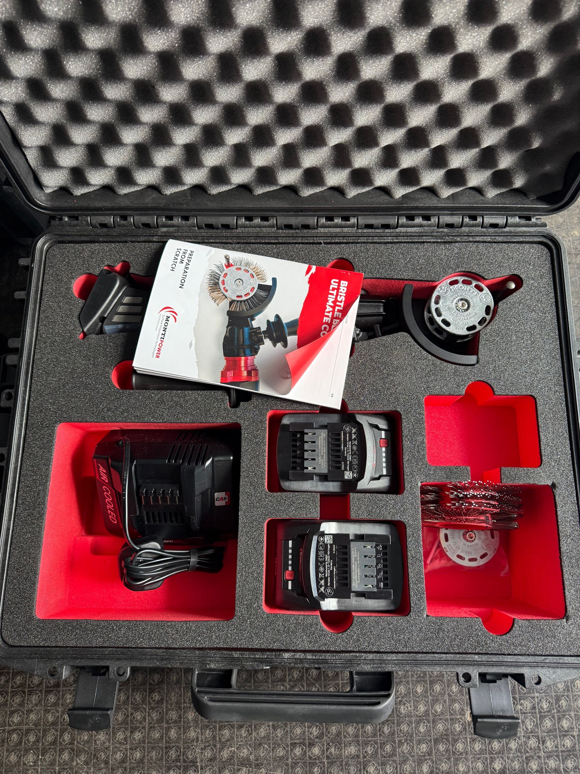 A briefcase filled with a variety of accessories for Monti Bristle Blaster.